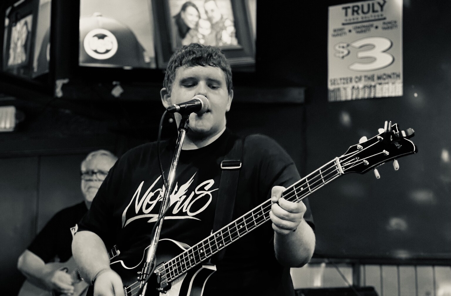 Jayce Walsh singing while playing bass