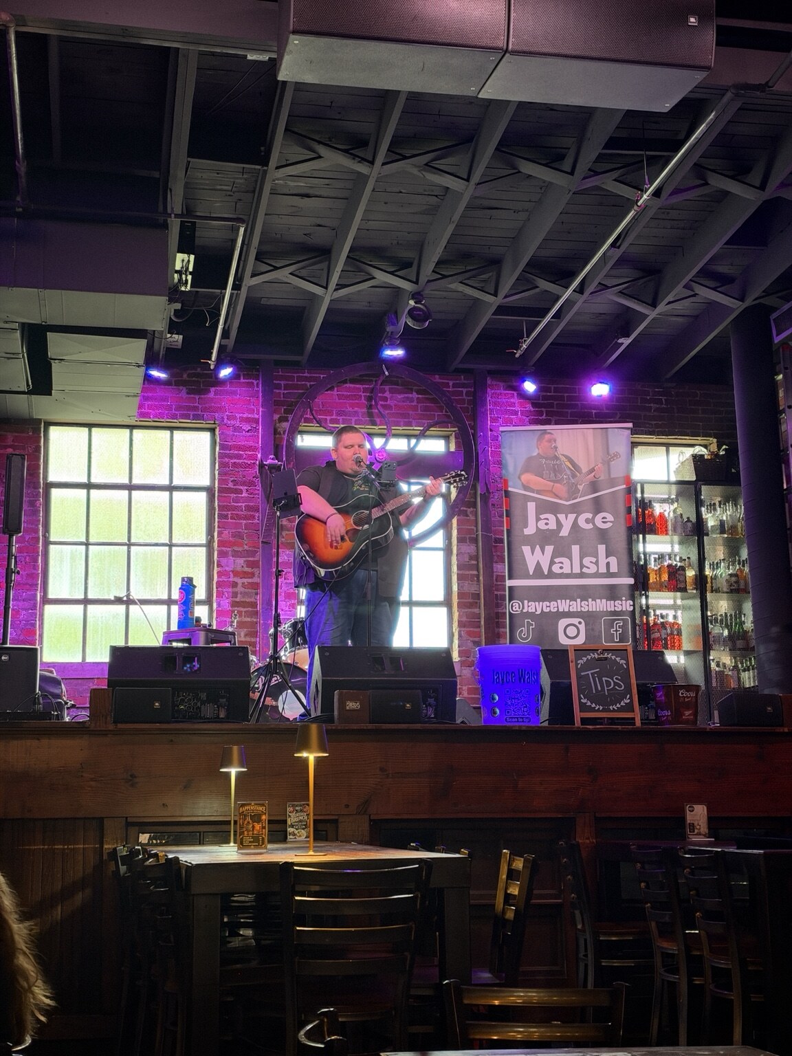 Jayce Walsh performing a solo acoustic set onstage